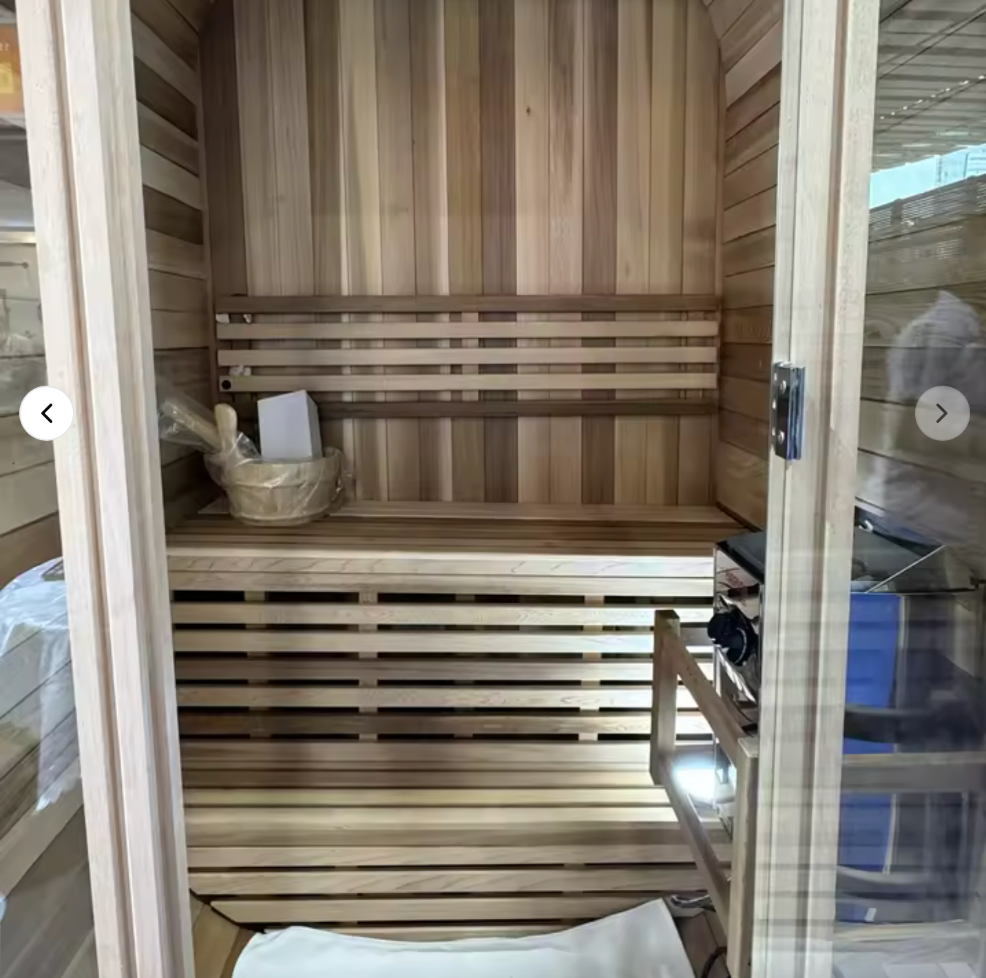 Auris One Luxury Outdoor Cedar Sauna interior view showing cedar wood benches sauna bucket with ladle and glass door