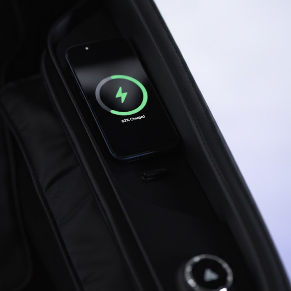 Floridian Brand Rebel 4D Massage Chair armrest wireless phone charging pad showing 62 percent battery indicator