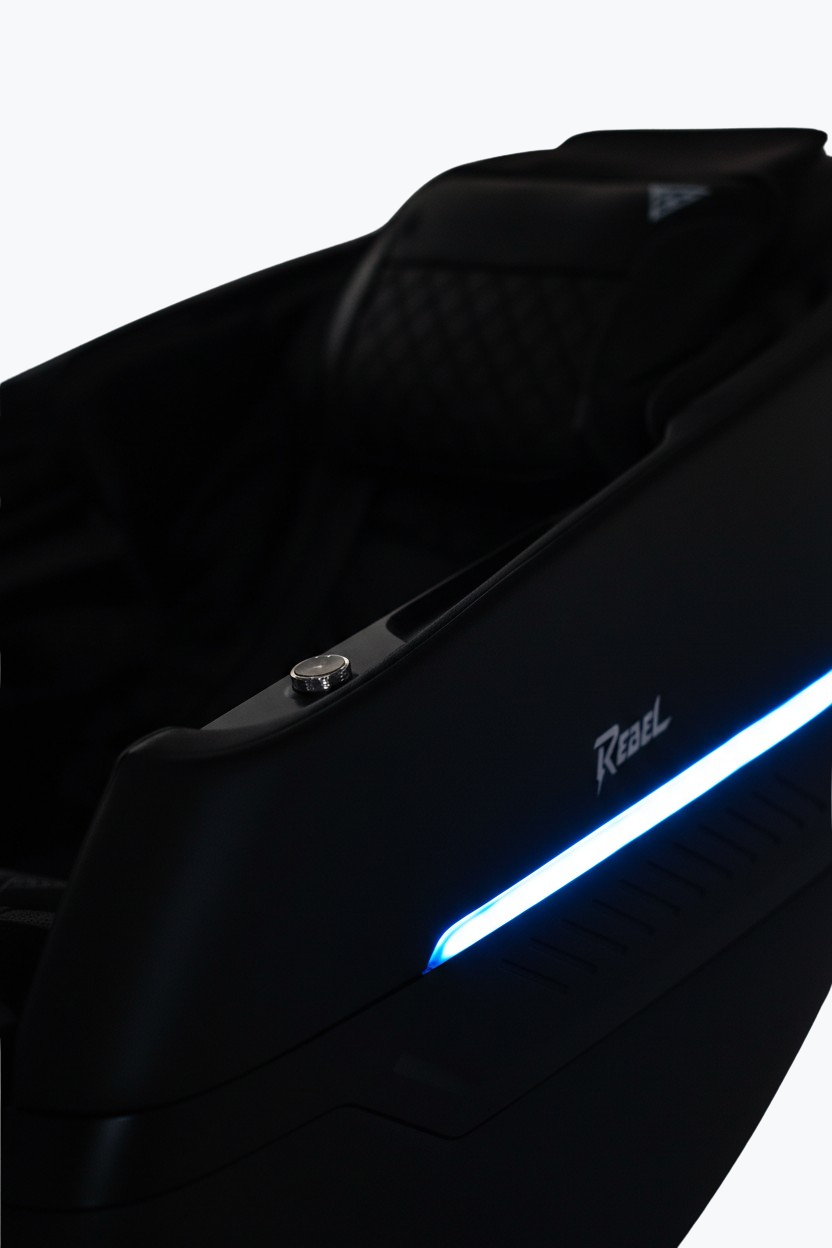 Person relaxing in fully reclined Floridian Brand Rebel 4D Massage Chair with blue LED ambient lighting from the side view.