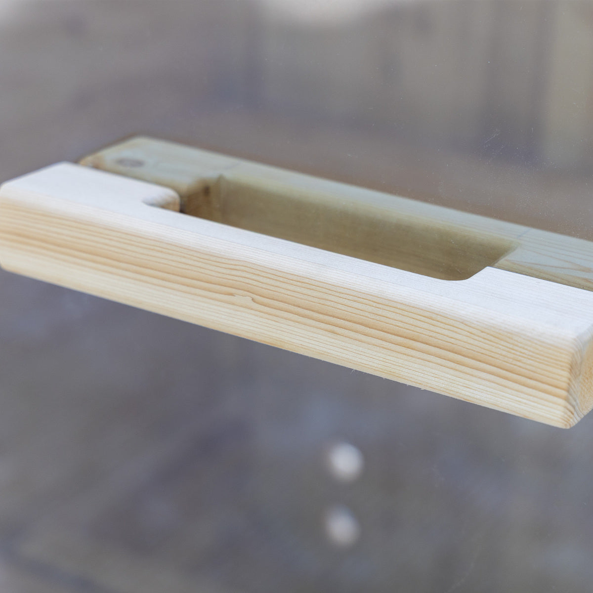 Auris One Luxury Outdoor Cedar Sauna close-up of natural cedar wood door handle with blurred background