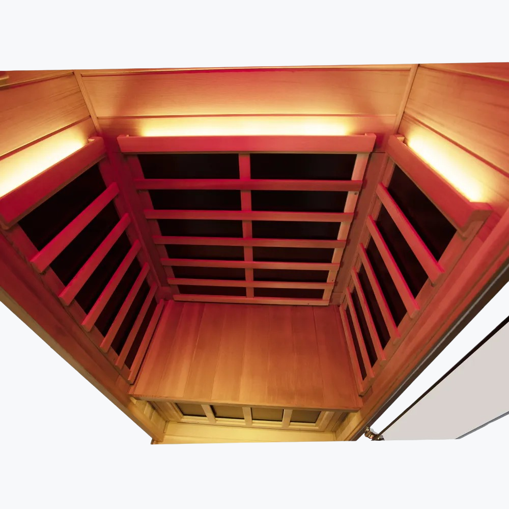 WizziSaunas 909MX Mini red cedar infrared sauna interior showing carbon crystal heater panels bench and floor slats assembled from a high angle.