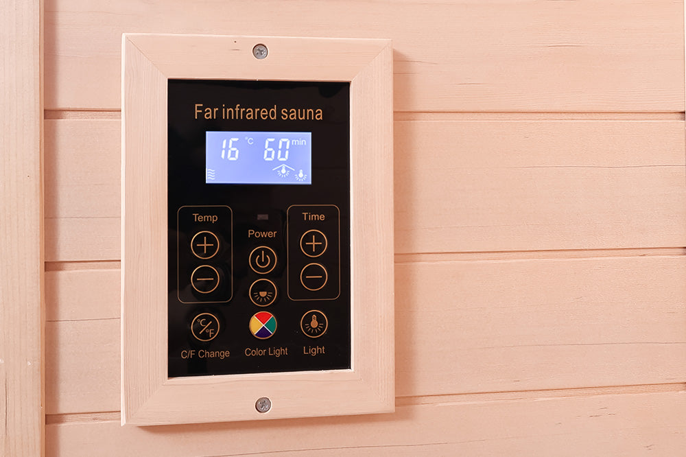 Control panel for a far infrared sauna with digital display and control buttons on a wooden wall.