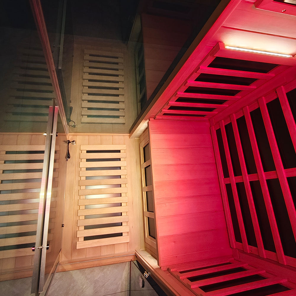 Infrared sauna with wooden interior and pink lighting