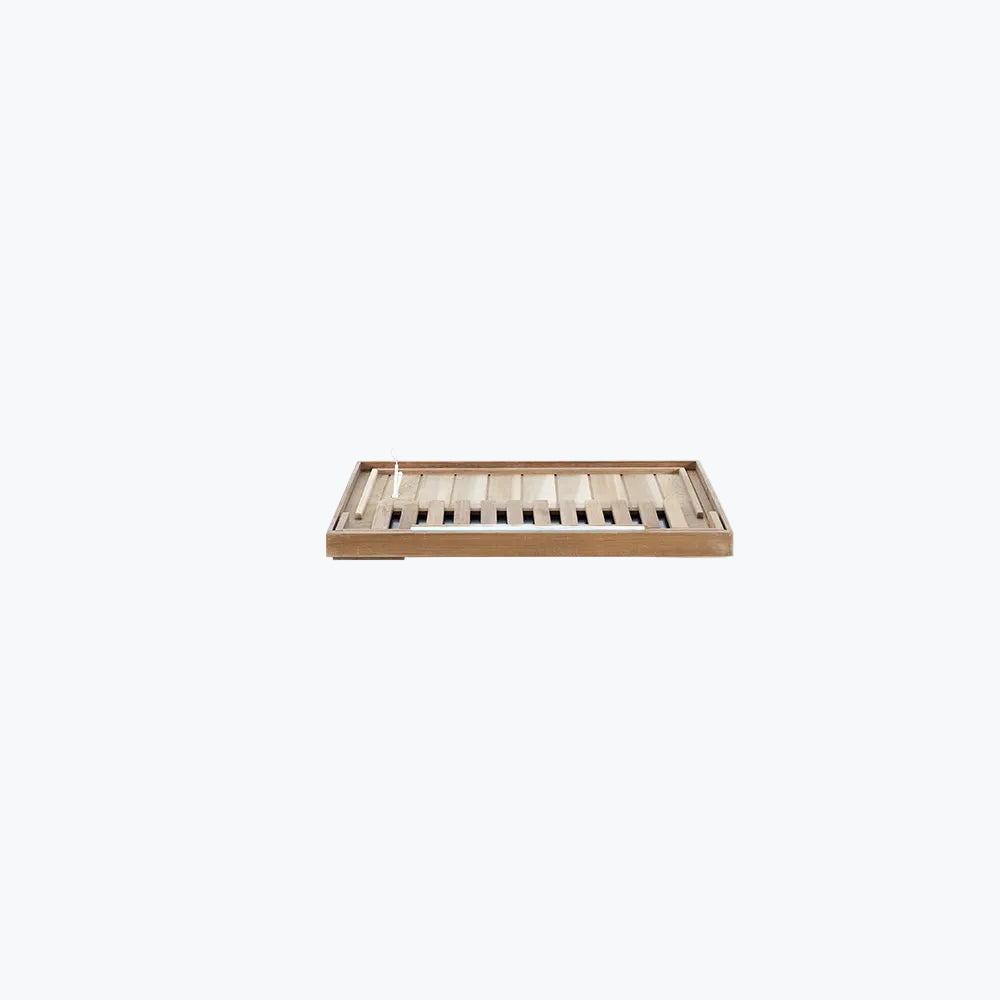 WizziSaunas SR01 Red Cedar Infrared Sauna floor panel angled view showing cedar wood slats drainage vents and raised feet on white background