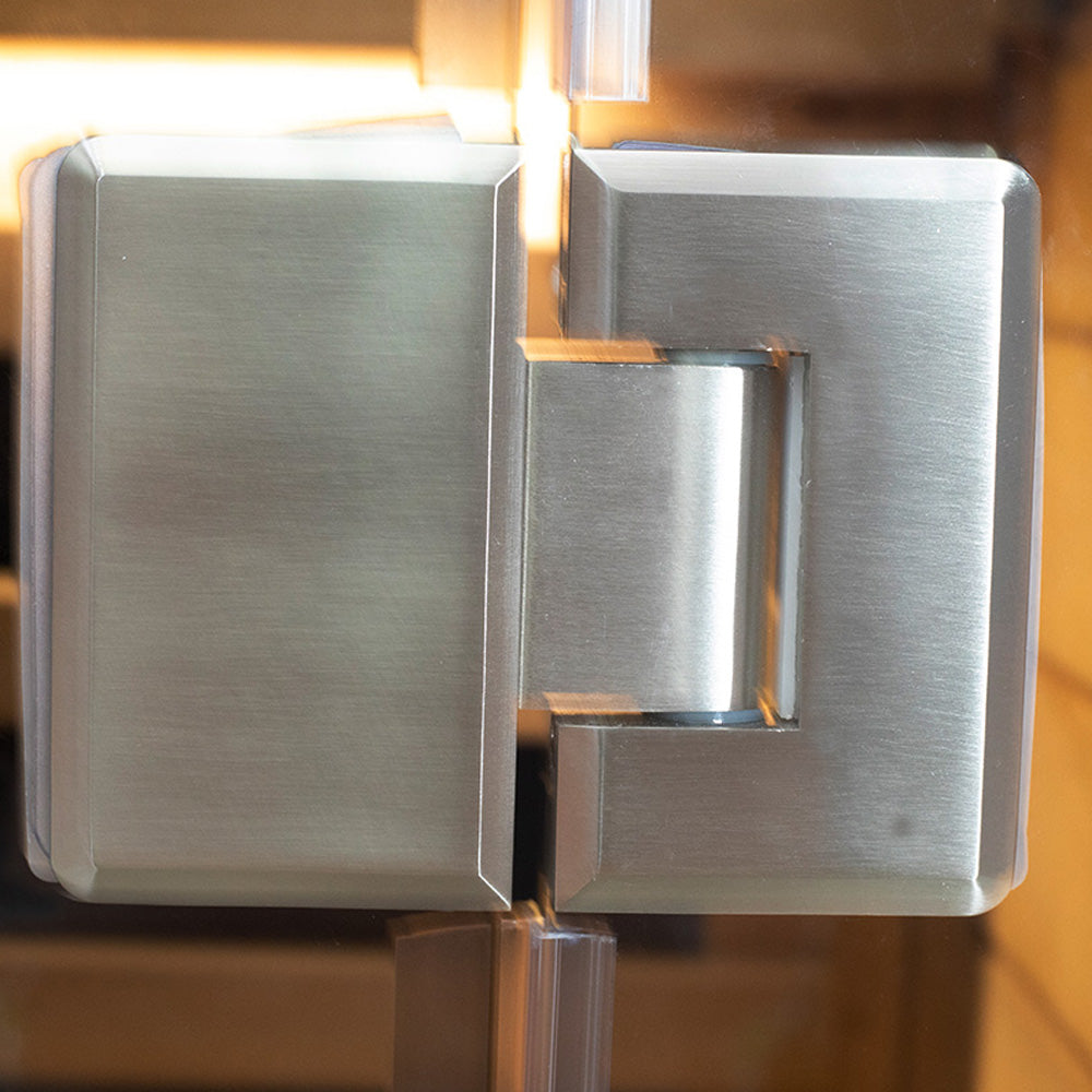 WizziSaunas SR01 Red Cedar Infrared Sauna close-up of heavy-duty stainless steel glass door hinge with warm cedar interior glow in background
