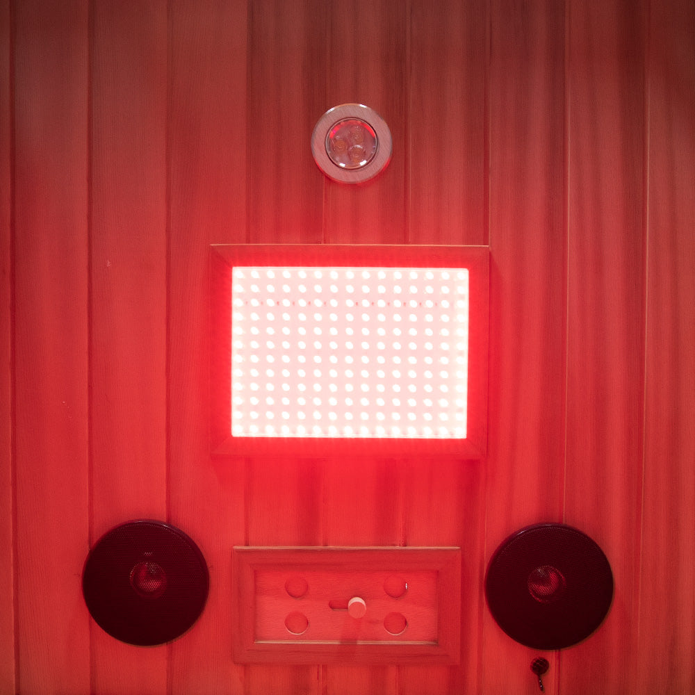 WizziSaunas SR01 Red Cedar Infrared Sauna interior close-up showing full spectrum LED light panel glowing red with chromotherapy ceiling light and two built-in Bluetooth speakers
