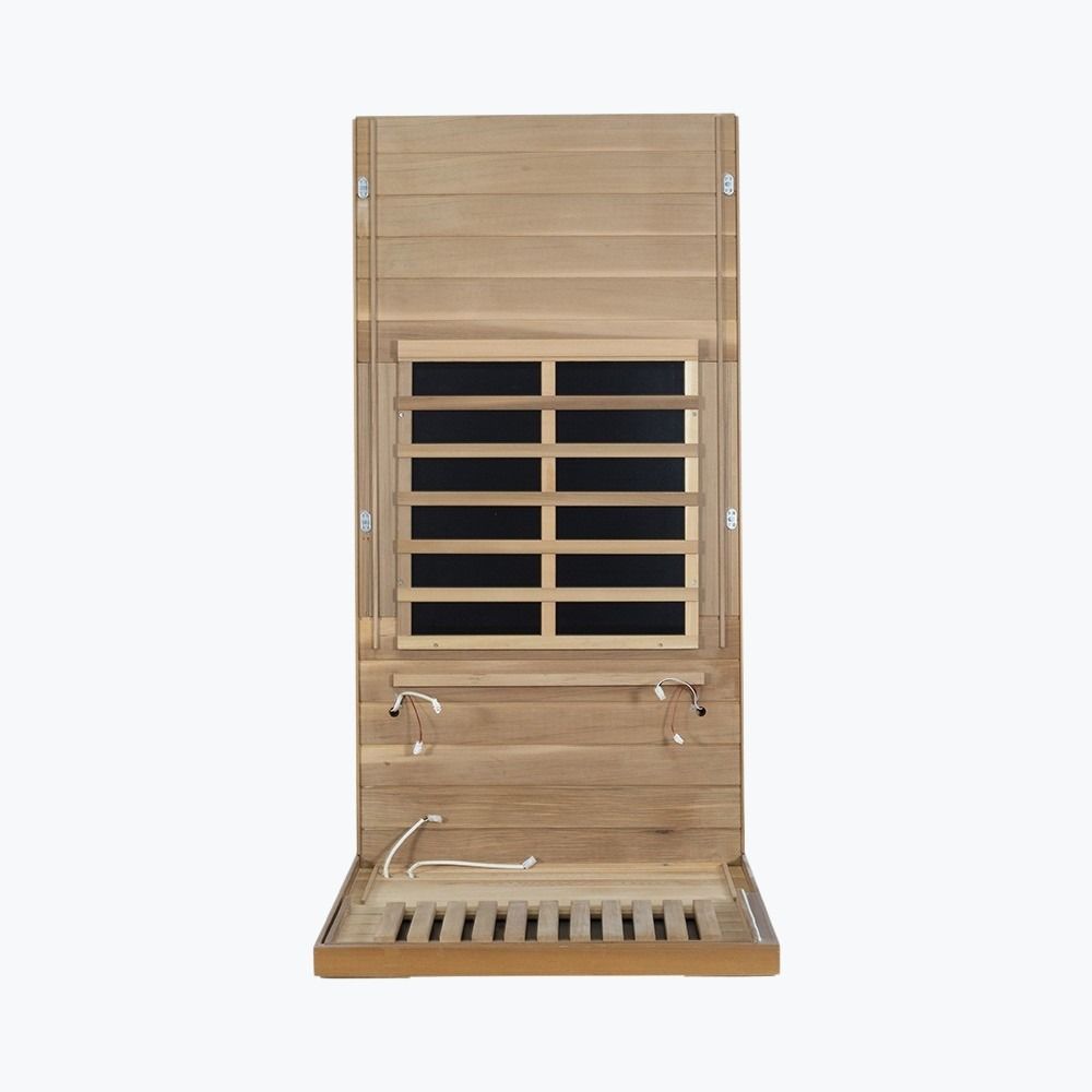 WizziSaunas 909MX Mini red cedar infrared sauna assembly step 2 — floor and first wall panel installed.