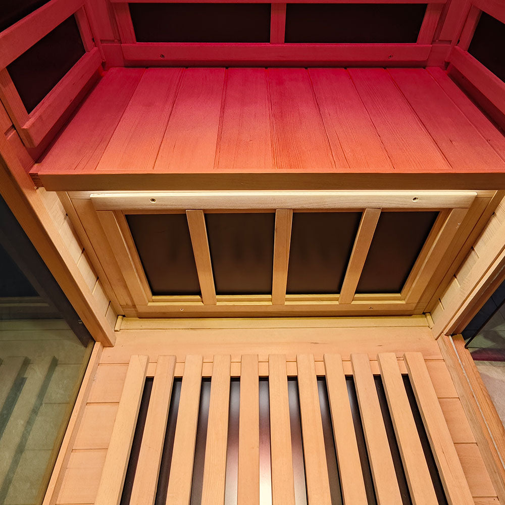 Wooden sauna with red interior and open door