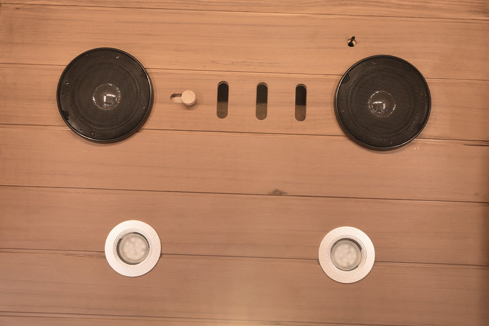 Wooden surface with electronic components including speakers and light bulbs.